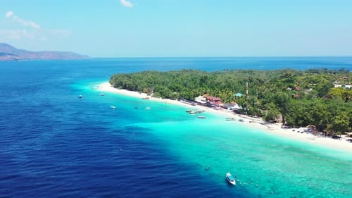 Beautiful island getaway with bright blue waters, white sand, and gorgeous greenery