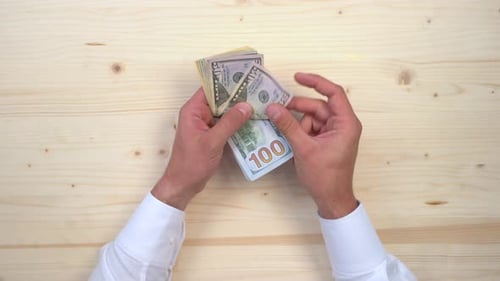 Hand grabbing dollars