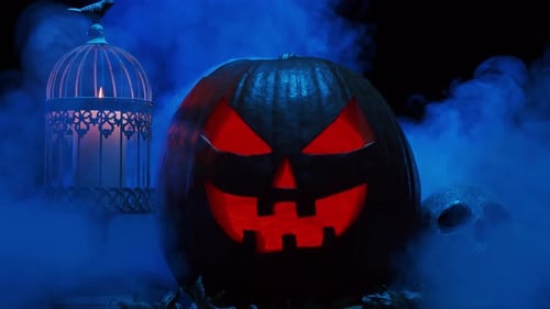 Halloween Pumpkin with Glowing Face in Dark Setting