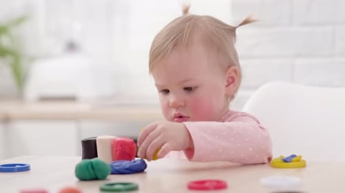Adorable Child Playing with Colorful Clay at Home