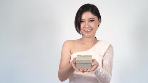 Young Woman Presenting Gift to the Viewer