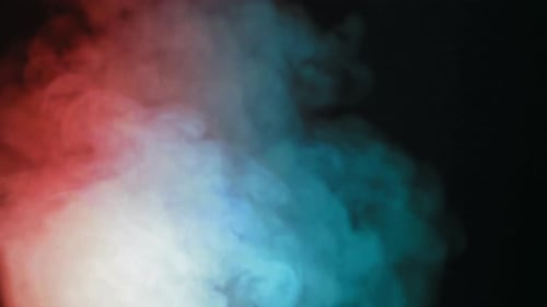 Red and Turquoise Smoke Billowing on Black Background
