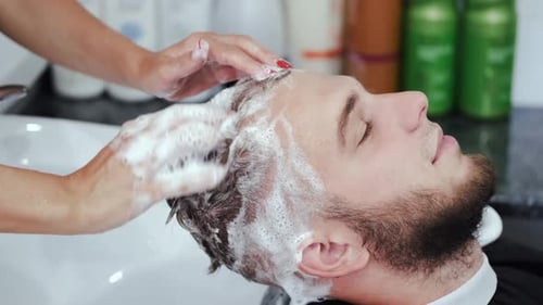 Man Receives a Hair Wash at the Barbershop