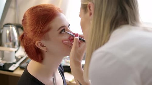 Makeup Artist Applies Eye Makeup to Woman