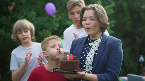 Happy 12 Years Old Teenage Girl Celebrating Birthday with Friends Blowing Out Candle on Cake in Slow