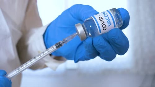 Drawing COVID-19 Vaccine from Vial with Syringe
