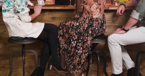 Revealing Shot of Young People Sitting at the Bar and Talking To the Bartender