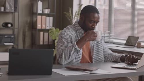 African-American Man Working on Laptop in Office