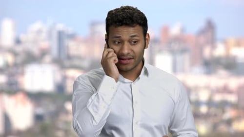 Young Adult Talks Angrily on the Phone