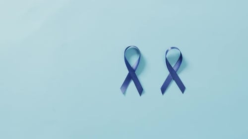 Video of two dark blue colon cancer ribbons on pale blue background