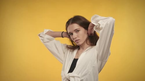 Stylish Woman Posing with Hands Behind Head