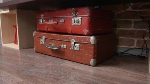 Vintage suitcases stacked under a table