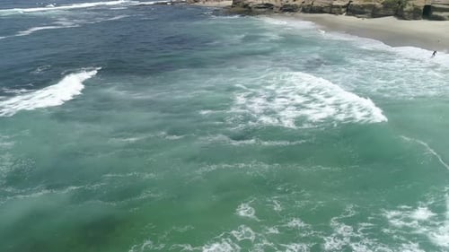 Aerial view of waves reaching the coast