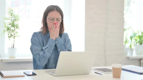 Woman with Cough Working at Computer in Office