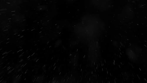 Low angle shot of rain falling against the black background. Loopable. HD