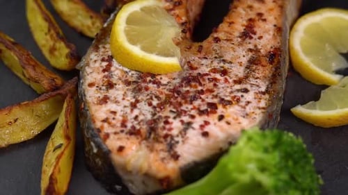 Close Up of Salmon Steak with Potatoes and Broccoli