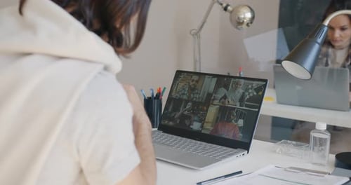 Businessman Discussing Project with Diverse Partners During Online Video Call with Laptop in Office
