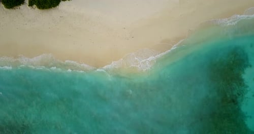 Wide angle fly over clean view of a summer white paradise sand beach and blue ocean background in be