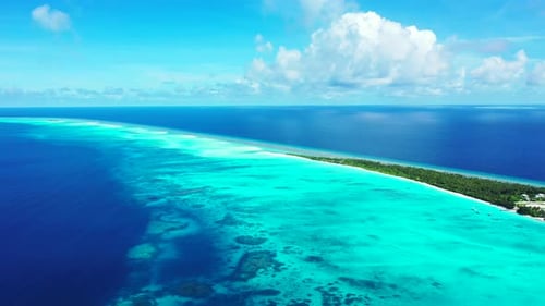 Daytime drone abstract view of a summer white paradise sand beach and blue sea background in 4K