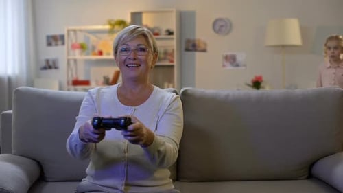 Grandmother and Granddaughter Play Video Games Together