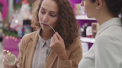 Women Shopping for Perfume in Department Store