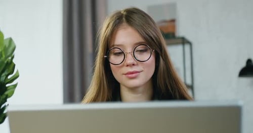 Woman Works on Computer at Home