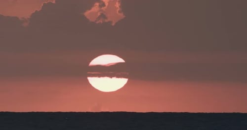 Sunset over the sea, super telephoto footage