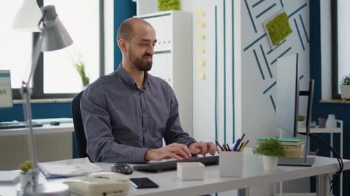 Man Working at Computer in Bright Modern Office