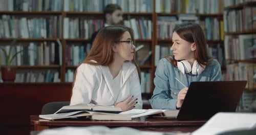Female Students Talking in Library