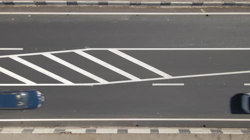 Aerial View of City Street with White Markings and Fast Driving Cars
