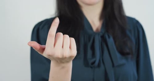 Woman beckoning with her finger