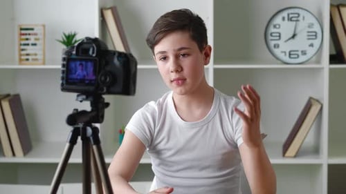Teen Boy Recording Video Blog At Home