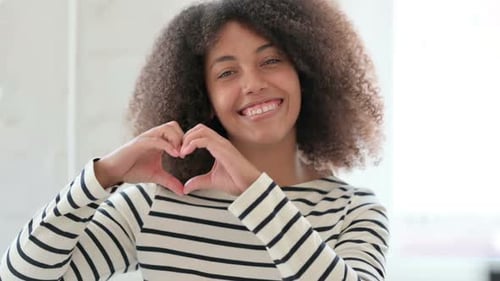 Woman Makes Heart Shape with Hands, Smiling