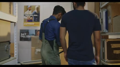 Workers Placing Road Cases on Shelves