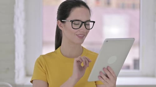 Portrait of Attractive Young Female Designer Using Tablet