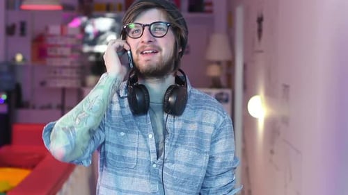 Young Adult Talking on Cell Phone Indoors