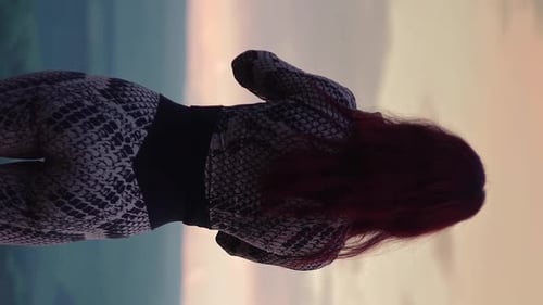 Woman Takes Phone Pictures Near Mountains at Sunset