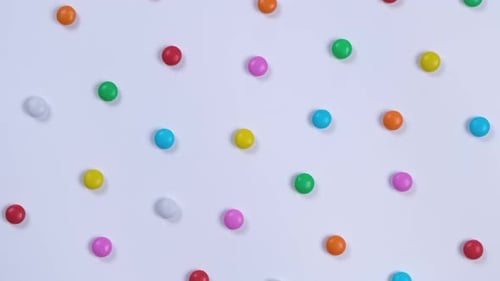 Bright Round Candies on White Surface