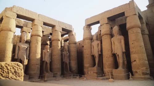 Tall pillars and pylons with rock statues in the Karnak Temple, Luxor, Egypt.
Slow camera movement