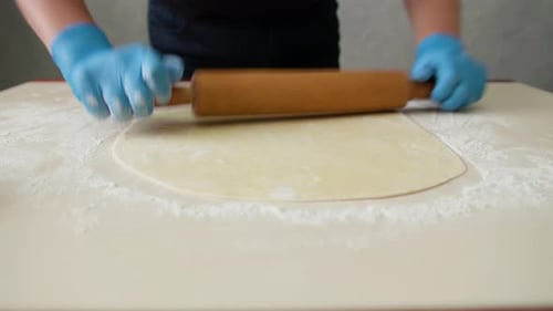 Chef Rolling Dough With Rolling Pin