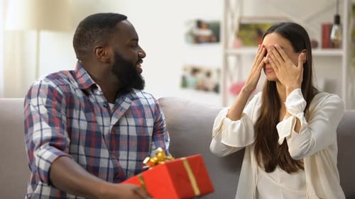 Man Giving Birthday Gift to Happy Girlfriend