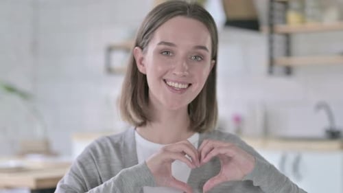 Woman Makes Heart Shape With Hands, Smiling