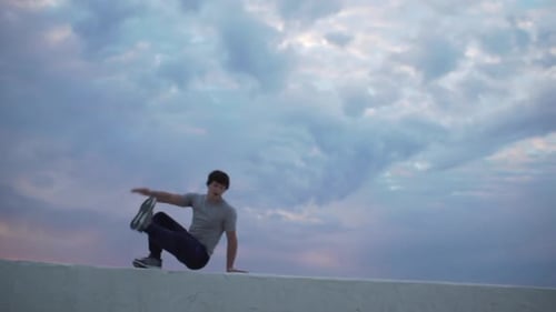 Young Man Performs Parkour Acrobatics Outdoors