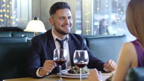 Elegant Man Dining with Wine at Restaurant