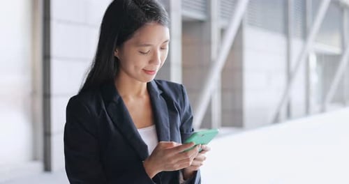 Business woman using mobile phone in the city