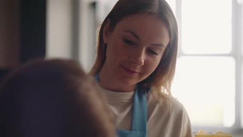 Mother and Daughter Baking Together in Kitchen