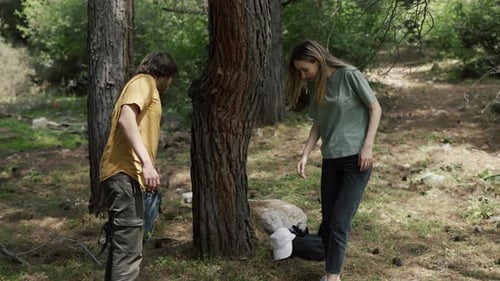 Young Couple Hiking and Resting in Forest