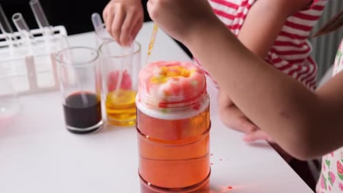 Children Conducting a Colorful Scientific Experiment at Home