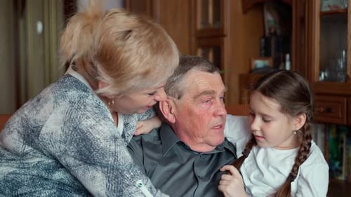 Loving Family Moment With Child and Senior Man