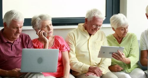 Seniors Using Technology Together Indoors